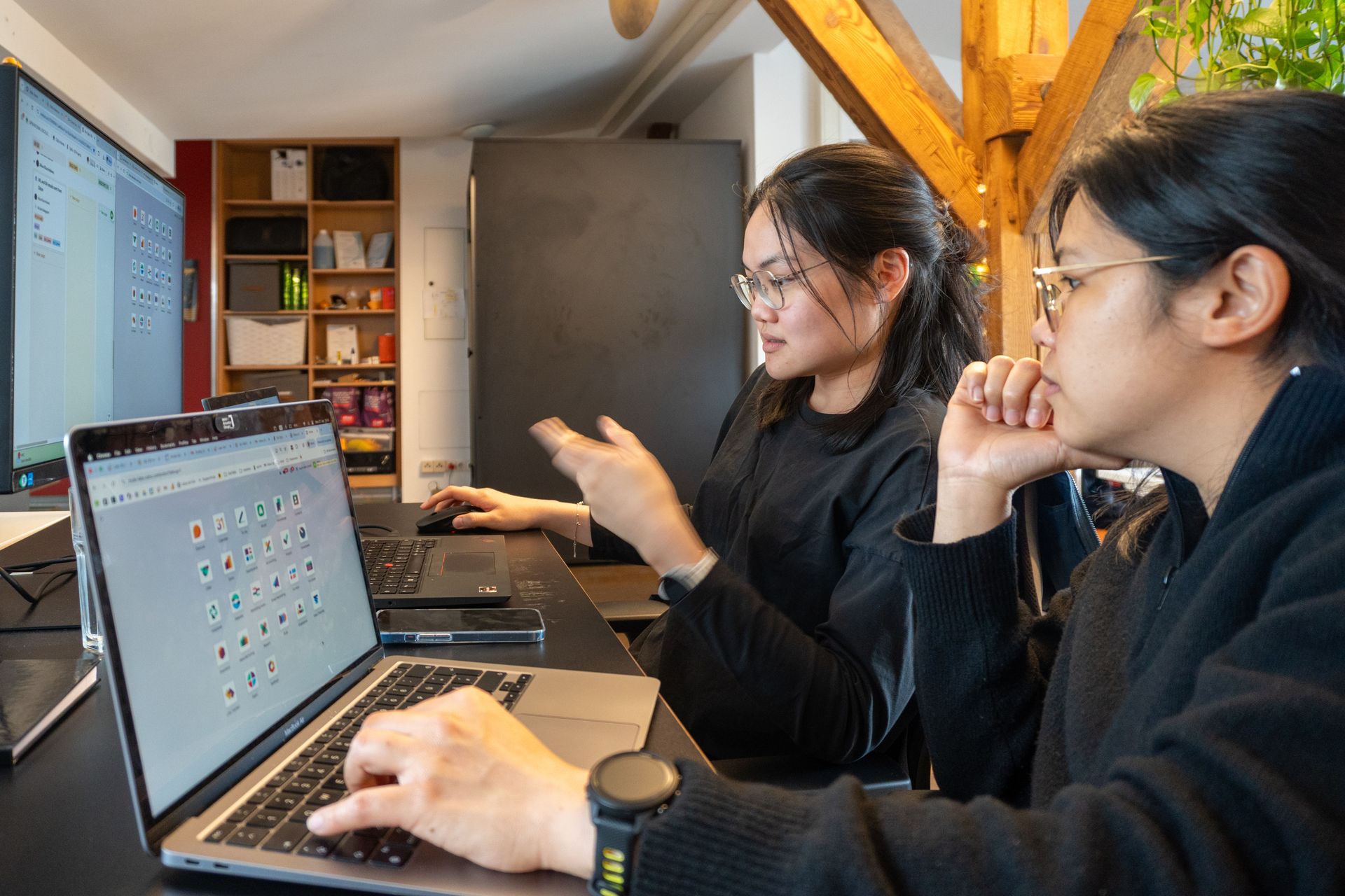 Two mute-labs employees collaborating on Odoo software dashboards in a modern Berlin office setting.