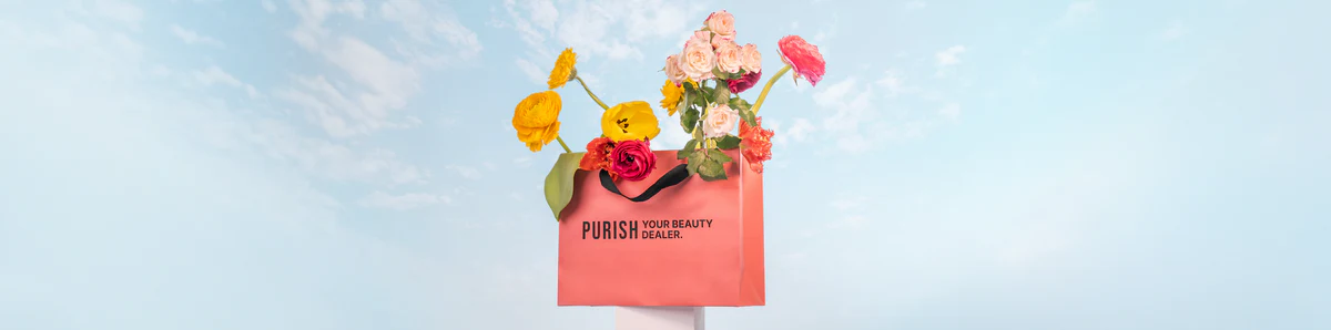 Purish e-commerce brand banner featuring a coral shopping bag filled with colorful flowers against a bright blue sky, reading Your Beauty Dealer.