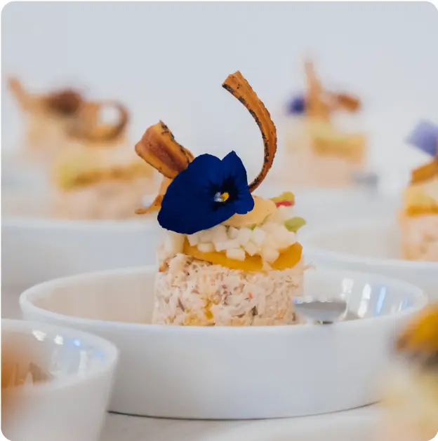 A nice chef's dish with a blue flower