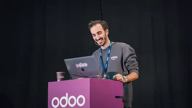 Smiling employee giving a talk on stage